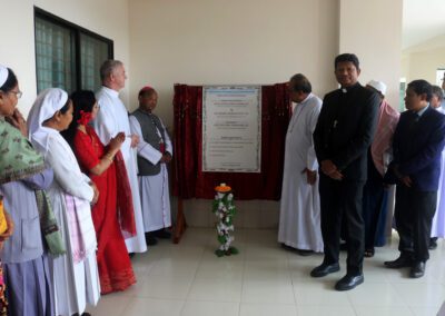 Rev. Thadeus Hembrom, C.S.C., Rev. Mrinal Michael Mrong, C.S.C., Rev. Thomas Eckert, C.S.C., and members of the community attend a blessing of the newly constructed Notre Dame College, Mymensingh.