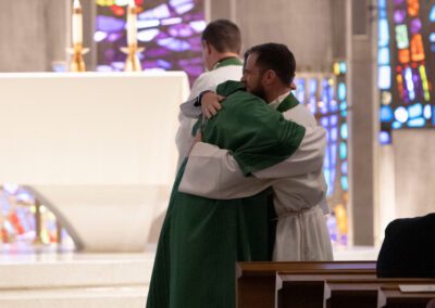 Fr. Romkema embraces Deacon Timothy Wymore at the altar during the diaconate ceremony.