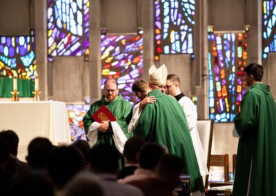 Most Reverend Bishop Kevin Rhoades, Bishop of the Diocese of Fort Wayne-South Bend, embraces Rev. Mr. Timothy Wymore, C.S.C., during the diaconate ceremony.