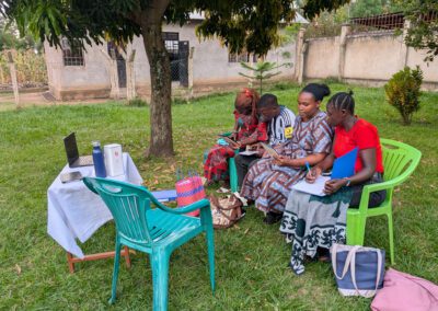 Group of educators of Eden Academy in Utegi, Tanzania outdoors having a meeting