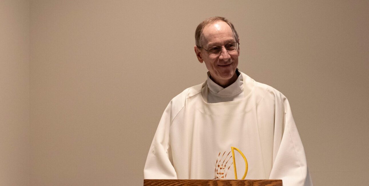 Fr Pacini at the altar giving a homily during daily Mass at St. Monica Church in South Bend.
