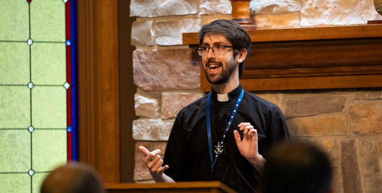 Fr. Ricky Bevington, C.S.C., speaks in front of a group at a retreat.