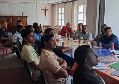 Group of men listening to a lecture at the Final Vows program in Le Mans, France.