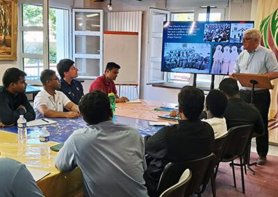 Group of men listening to Brother Paul Bednarczyk, C.S.C., lecture at the Final Vows program in Le Mans, France.