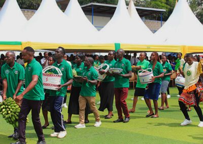 Visitors process holding flags around the school building at the Holy Cross Lake View S.S.S. Laudato Si' festival
