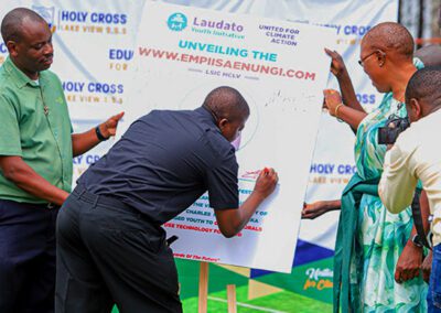 Holy Cross religious sign a new program poster at the Holy Cross Lake View S.S.S. Laudato Si' festival