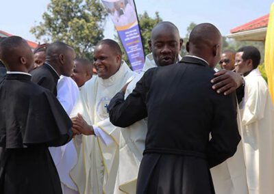 Men of the Province of East Africa hugging one another in celebration at the profession of First Vows Mass.