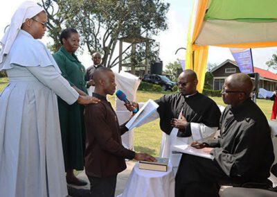 Men of the Province of East Africa, kneeling in prayer at the profession of First Vows ceremony.
