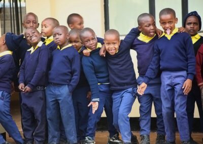Young male students at St. Brendan Kitete school post outside the school building