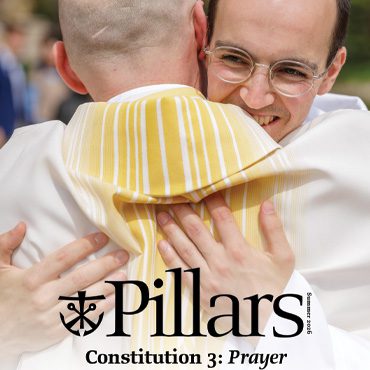 Summer 2026 Pillars Magazine Cover Cover of the summer 2026 edition of the Pillars magazine with a picture from ordination of men hugging in celebration after Mass.