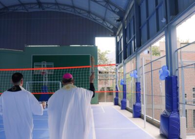 Holy Cross religious blessing the inside of the new Brother Juan Benesh, C.S.C., Mini Coliseum in Lima, Peru.