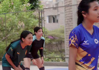 Two young women playing volleyball at the new Brother Juan Benesh, C.S.C., Mini Coliseum in Lima, Peru.