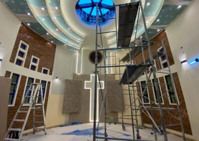 Inside construction including painting the walls of the altar at the chapel at Casa San José (Saint Joseph House of Formation) in Canto Grande, Peru