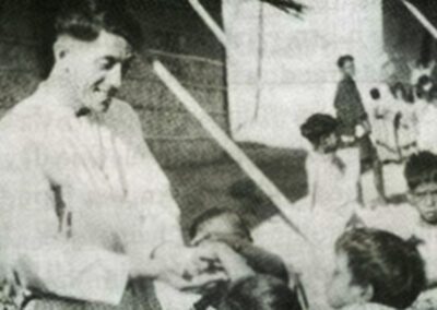 Br. Flavian Laplante, C.S.C. playing with young children outdoor.